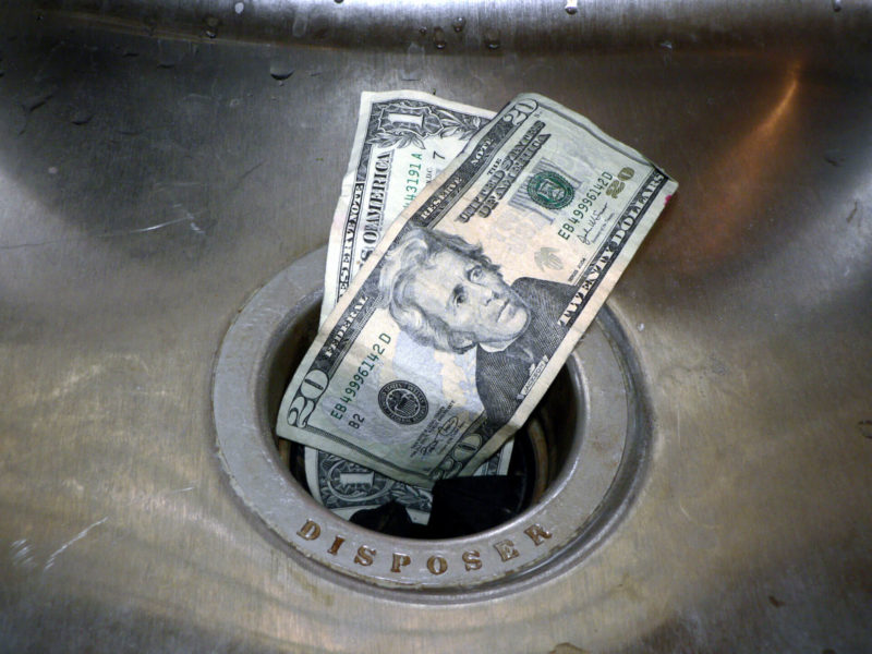 Money Down The Drain Shutterstock 1703333