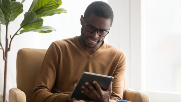 Man-checking-news-on-an-ipad