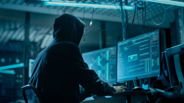 Bad-guy-in-a-hoodie-installing-malware