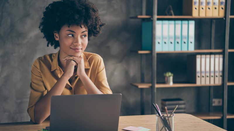 Woman on a laptop, thinking.