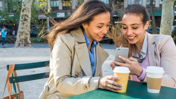 two_women_reading_phone