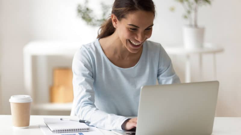 Woman typing into her laptop.