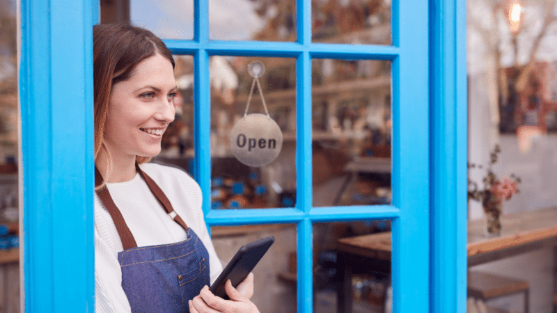 Local business owner holding a tablet.