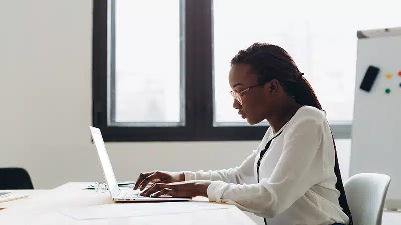 Woman at desk working on laptop